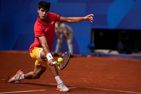 Carlos Alcaraz backhands to Serbia's Novak Djokovic 